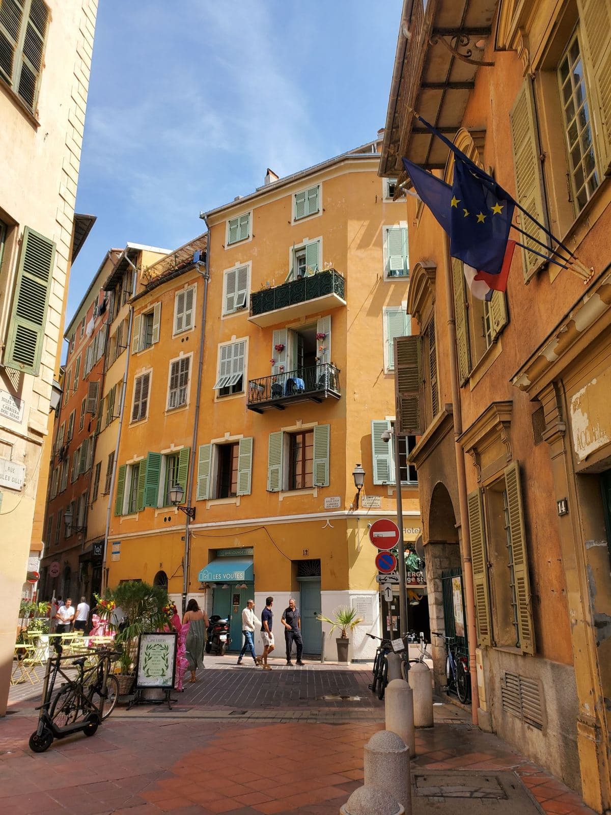 A sunlit ochre street corner in the old town of Nice